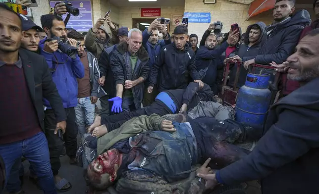 REMOVES NUMBER OF KILLED - The bodies of men killed in an Israeli army strike targeting a car are brought to Al-Aqsa Martyrs hospital in Deir al-Balah Friday, Jan. 3, 2025.(AP Photo/Abdel Kareem Hana)