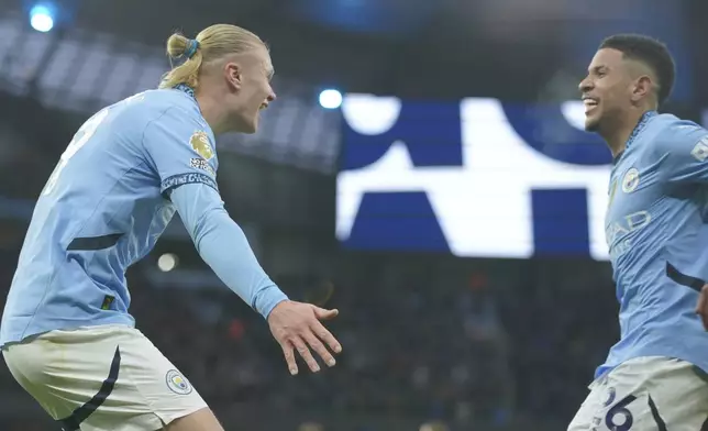 Manchester City's Erling Haaland, left, is congratulated by Savinho after scoring his side's 2nd goal against West Ham during a English Premier League soccer match at Etihad stadium in Manchester, England, Saturday, Jan. 4, 2025. (AP Photo/Ian Hodgson)