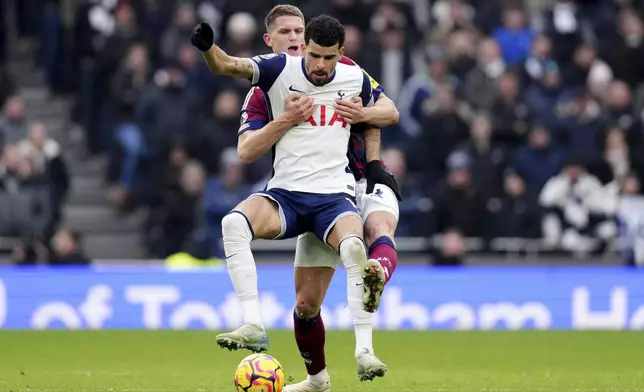 Tottenham Hotspur's Dominic Solanke, front, and Newcastle United's Sven Botman battle for the ball during the English Premier League soccer match between Tottenham Hotspur and Newcastle United at the Tottenham Hotspur Stadium, London, Saturday Jan. 4, 2025. (John Walton/PA via AP)