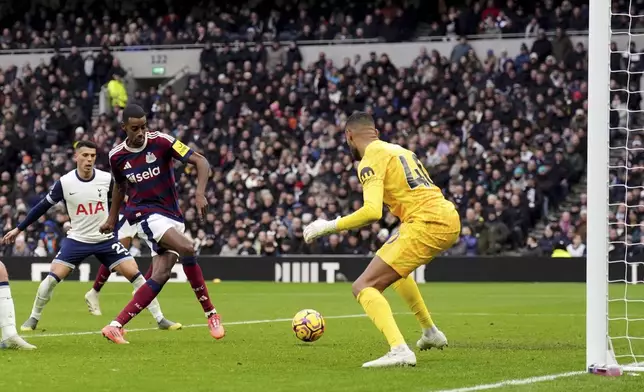 Newcastle United's Alexander Isak score past Tottenham's Brandon Austin during the English Premier League soccer match between Tottenham Hotspur and Newcastle United at the Tottenham Hotspur Stadium, London, Saturday Jan. 4, 2025. (John Walton/PA via AP)