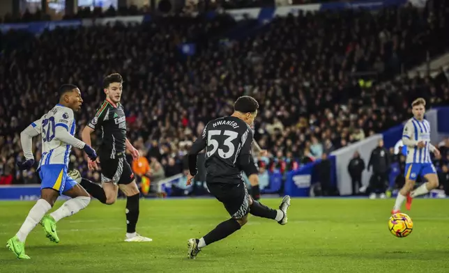 Arsenal's Ethan Nwaneri scores the opening goal during the English Premier League soccer match between Brighton and Hove Albion FC and Arsenal at the Amex stadium in Brighton, Saturday, Jan. 4, 2025. (AP Photo/Ian Walton)