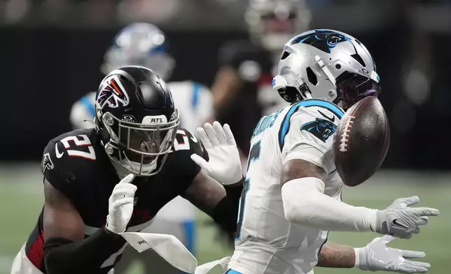 Carolina Panthers running back Miles Sanders loses control of the ball against the Atlanta Falcons during the first half of an NFL football game, Sunday, Jan. 5, 2025, in Atlanta. (AP Photo/Mike Stewart)