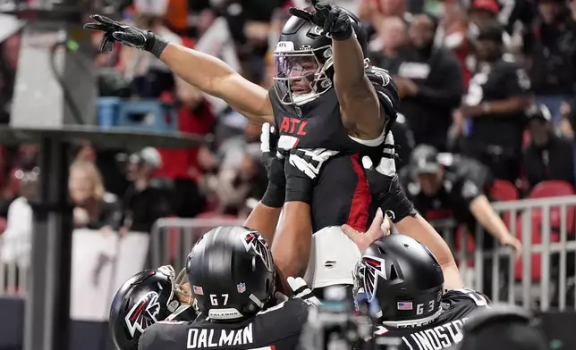 Atlanta Falcons running back Bijan Robinson celebrates after scoring against the Carolina Panthers during the first half of an NFL football game, Sunday, Jan. 5, 2025, in Atlanta. (AP Photo/Mike Stewart)