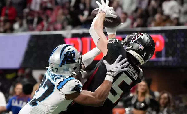 Atlanta Falcons wide receiver Drake London catches a touchdown pass in front of Carolina Panthers cornerback Shemar Bartholomew during the first half of an NFL football game, Sunday, Jan. 5, 2025, in Atlanta. (AP Photo/Mike Stewart)