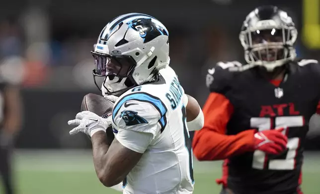 Carolina Panthers running back Miles Sanders scores against the Atlanta Falcons during the first half of an NFL football game, Sunday, Jan. 5, 2025, in Atlanta. (AP Photo/Brynn Anderson)