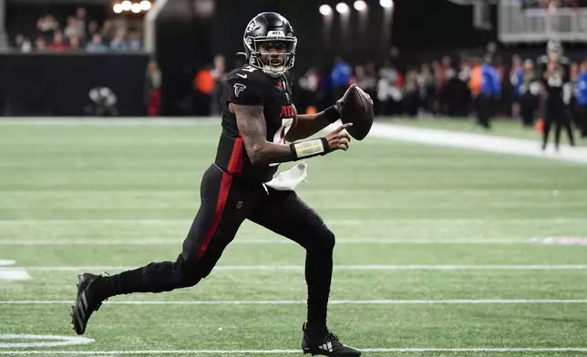 Atlanta Falcons quarterback Michael Penix Jr. runs for a touchdown against the Carolina Panthers during the first half of an NFL football game, Sunday, Jan. 5, 2025, in Atlanta. (AP Photo/Mike Stewart)