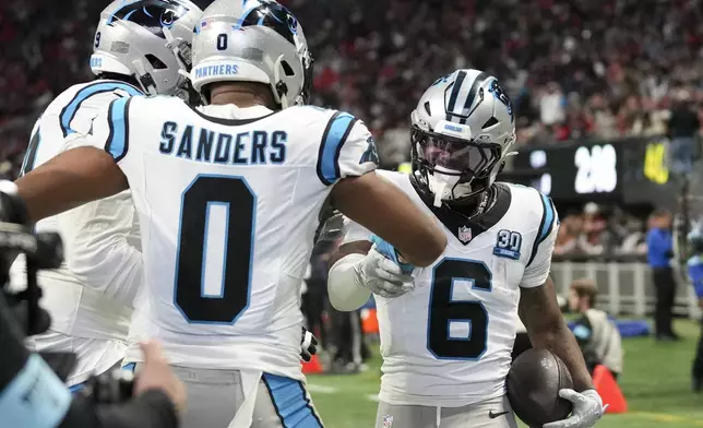 Carolina Panthers running back Miles Sanders celebrates after scoring against the Atlanta Falcons during the first half of an NFL football game, Sunday, Jan. 5, 2025, in Atlanta. (AP Photo/Brynn Anderson)