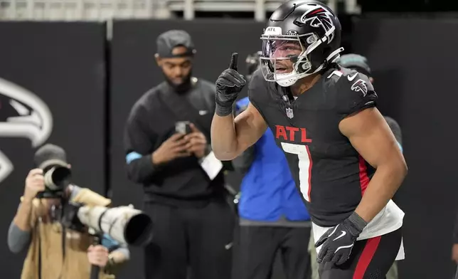 Atlanta Falcons running back Bijan Robinson celebrates after scoring against the Carolina Panthers during the first half of an NFL football game, Sunday, Jan. 5, 2025, in Atlanta. (AP Photo/Mike Stewart)