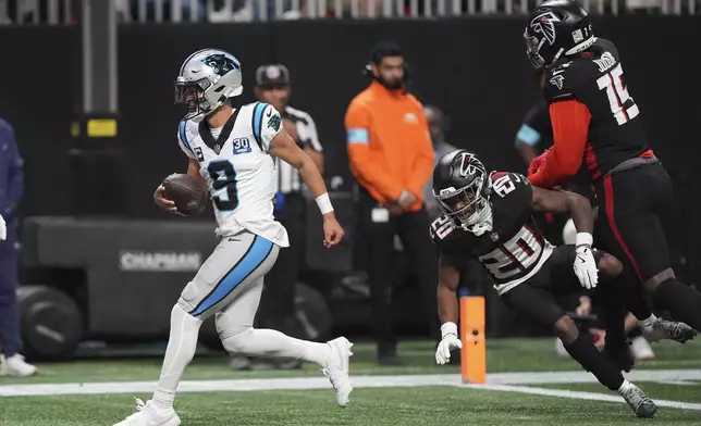 Carolina Panthers quarterback Bryce Young scores against the Atlanta Falcons during the second half of an NFL football game, Sunday, Jan. 5, 2025, in Atlanta. (AP Photo/Brynn Anderson)