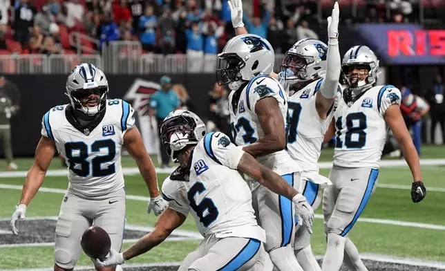 Carolina Panthers running back Miles Sanders celebrates after scoring the game wining touchdown against the Atlanta Falcons during overtime in an NFL football game, Sunday, Jan. 5, 2025, in Atlanta. (AP Photo/Mike Stewart)