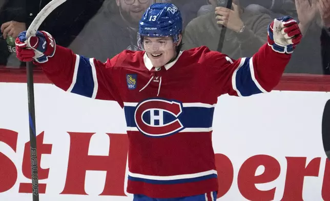 Montreal Canadiens right wing Cole Caufield celebrates after scoring the first goal against the Vancouver Canucks during first-period NHL hockey game action in Montreal, Monday, Jan. 6, 2025. (Ryan Remiorz/The Canadian Press via AP)