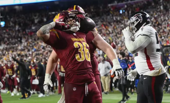 ]Washington Commanders running back Chris Rodriguez Jr. (36) celebrates his touchdown during the second half of an NFL football game against the Atlanta Falcons, Sunday, Dec. 29, 2024, in Landover, Md. (AP Photo/Nick Wass)