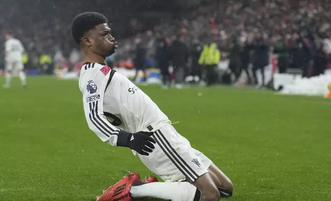 Manchester United's Amad Diallo celebrates after scoring his side's 2nd goal against Liverpool during the English Premier League soccer match at the Anfield stadium in Liverpool, England, Sunday, Jan. 5, 2025. (AP Photo/Jon Super)