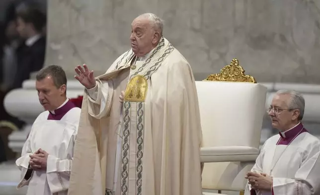 Pope Francis is flanked by Vatican Head Master of Ceremonies, Bishop Diego Giovanni Ravelli, right, and Master of Ceremonies, Bishop Krysztof Marcjanowicz as he presides over a mass in St. Peter's Basilica at The Vatican on New Year's Day, Wednesday, Jan. 1, 2025. (AP Photo/Andrew Medichini)