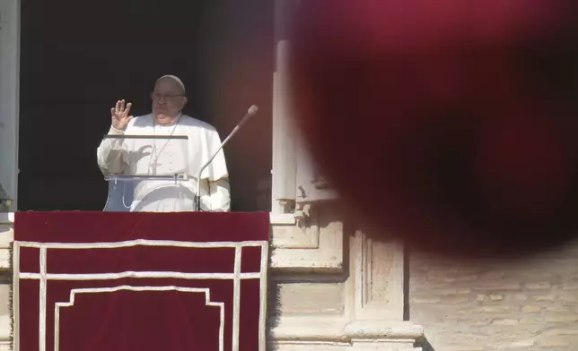 Pope Francis appears at his studio's window overlooking St. Peter's Square at The Vatican to bless pilgrims and faithful after presiding over a mass in St. Peter's Basilica on New Year's Day, Wednesday, Jan. 1, 2025. (AP Photo/Andrew Medichini)