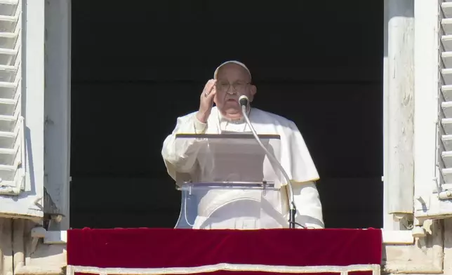 Pope Francis appears at his studio's window overlooking St. Peter's Square at The Vatican to bless pilgrims and faithful after presiding over a mass in St. Peter's Basilica on New Year's Day, Wednesday, Jan. 1, 2025. (AP Photo/Andrew Medichini)