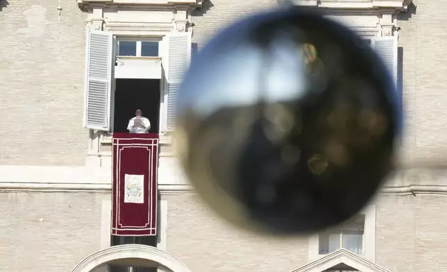 Pope Francis appears at his studio's window overlooking St. Peter's Square at The Vatican to bless pilgrims and faithful after presiding over a mass in St. Peter's Basilica on New Year's Day, Wednesday, Jan. 1, 2025. (AP Photo/Andrew Medichini)