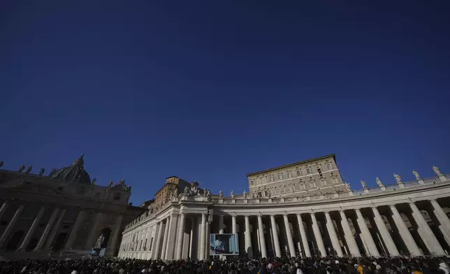 Pope Francis appears at his studio's window overlooking St. Peter's Square at The Vatican to bless pilgrims and faithful after presiding over a mass in St. Peter's Basilica on New Year's Day, Wednesday, Jan. 1, 2025. (AP Photo/Andrew Medichini)