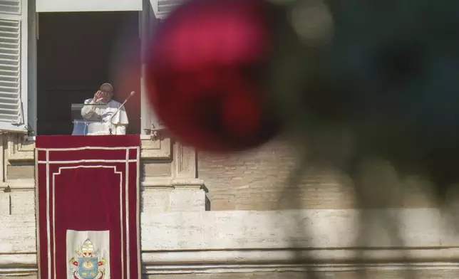 Pope Francis appears at his studio's window overlooking St. Peter's Square at The Vatican to bless pilgrims and faithful after presiding over a mass in St. Peter's Basilica on New Year's Day, Wednesday, Jan. 1, 2025. (AP Photo/Andrew Medichini)