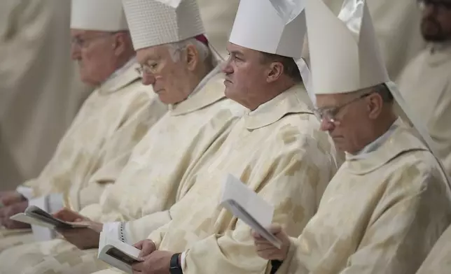 Bishops follow Pope Francis presiding over a mass in St. Peter's Basilica at The Vatican on New Year's Day, Wednesday, Jan. 1, 2025. (AP Photo/Andrew Medichini)