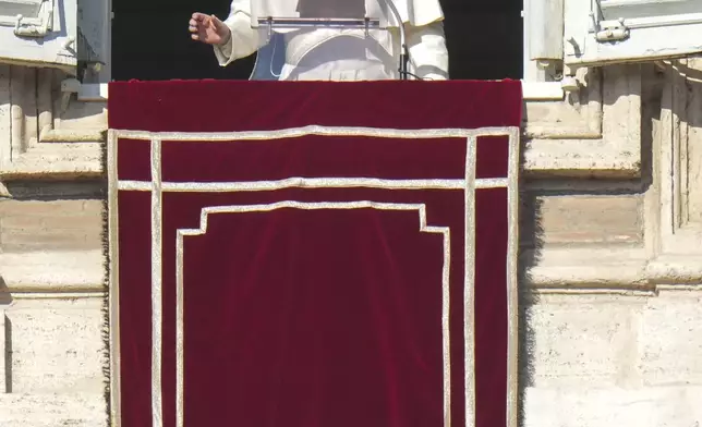 Pope Francis appears at his studio's window overlooking St. Peter's Square at The Vatican to bless pilgrims and faithful after presiding over a mass in St. Peter's Basilica on New Year's Day, Wednesday, Jan. 1, 2025. (AP Photo/Andrew Medichini)