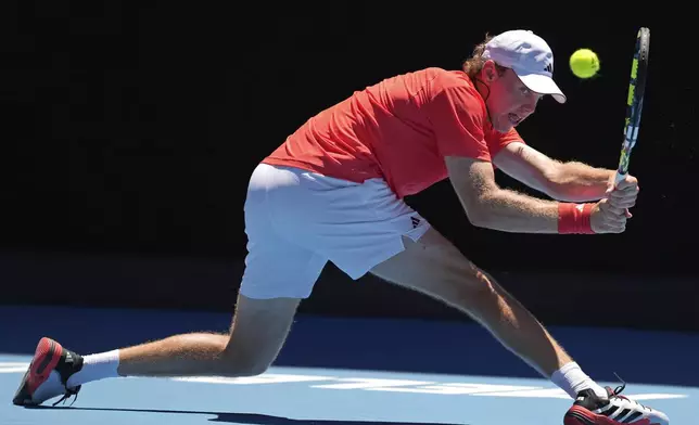 Alex Michelsen of the U.S. plays a backhand return to Karen Khachanov of Russia during their third round match at the Australian Open tennis championship in Melbourne, Australia, Saturday, Jan. 18, 2025. (AP Photo/Ng Han Guan)