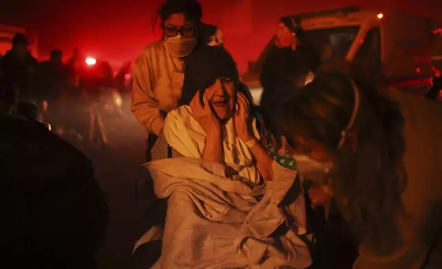 A resident of a senior center is evacuated as the Eaton Fire approaches Tuesday, Jan. 7, 2025 in Altadena, Calif. (AP Photo/Ethan Swope)