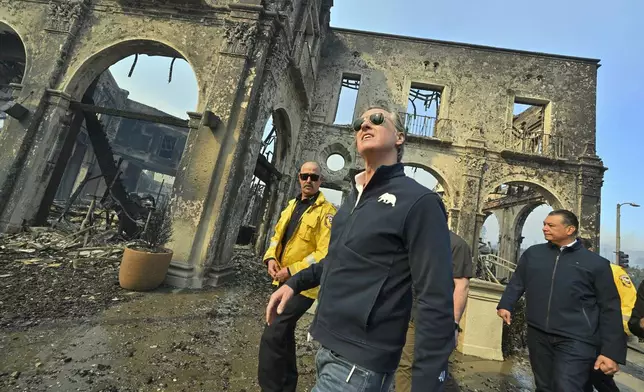 California Governor Gavin Newsom, center, surveys damage in Pacific Palisades with CalFire's Nick Schuler, left, and Senator Alex Padilla, D-Calif., during the Palisades Fire Wednesday, Jan. 8, 2025, in Pacific Palisades, Calif. (Jeff Gritchen/The Orange County Register via AP)