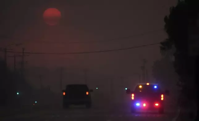 The Palisades Fire ravages a neighborhood amid high winds in the Pacific Palisades neighborhood of Los Angeles, Wednesday, Jan. 8, 2025. (AP Photo/Damian Dovarganes)