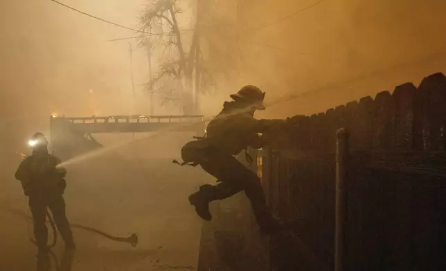 Fire crews battle the Eaton Fire Wednesday, Jan. 8, 2025 in Altadena, Calif. (AP Photo/Ethan Swope)