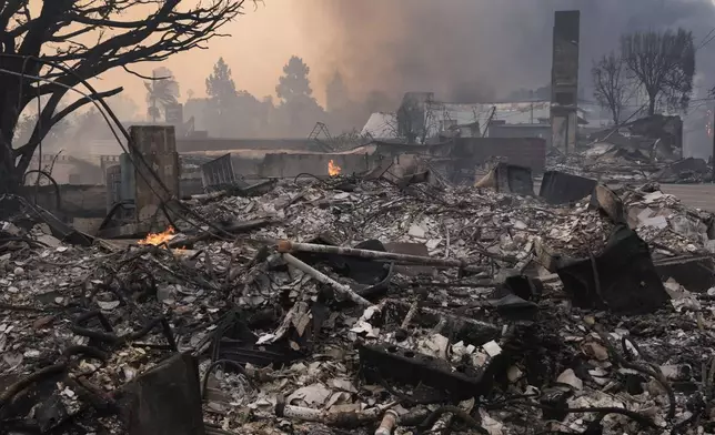 The Palisades Fire ravages a neighborhood amid high winds in the Pacific Palisades neighborhood of Los Angeles, Wednesday, Jan. 8, 2025. (AP Photo/Damian Dovarganes)