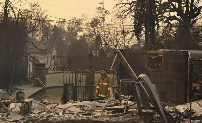 Robert Lara looks through his home that was destroyed after the Eaton Fire burns in Altadena, Calif., Thursday, Jan. 9, 2025. (AP Photo/Nic Coury)