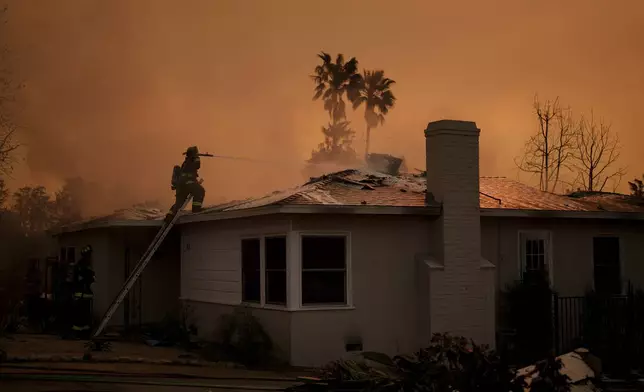 Fire crews battle the Eaton Fire as it impacts a structure Thursday, Jan. 9, 2025 in Altadena, Calif. (AP Photo/Eric Thayer)