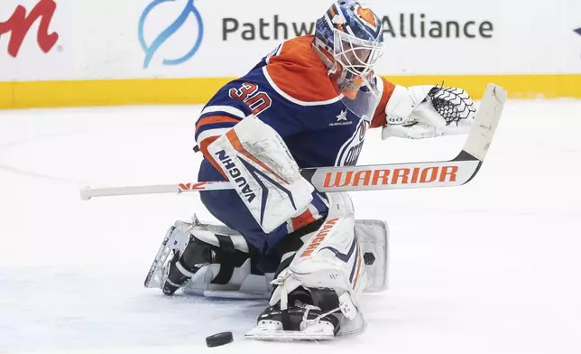 Edmonton Oilers goalie Calvin Pickard (30) makes a save during the third period of an NHL hockey game against the Seattle Kraken in Edmonton, Alberta, Monday, Jan. 27, 2025. (Jason Franson/The Canadian Press via AP)