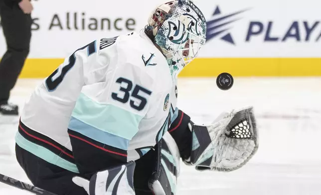Seattle Kraken goalie Joey Daccord makes a save against the Edmonton Oilers during second-period NHL hockey game action in Edmonton, Alberta, Monday, Jan. 27, 2025. (Jason Franson/The Canadian Press via AP)