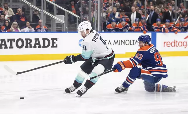 Seattle Kraken's Chandler Stephenson (9) breaks away from Edmonton Oilers' Ryan Nugent-Hopkins (93) during first-period NHL hockey game action in Edmonton, Alberta, Monday, Jan. 27, 2025. (Jason Franson/The Canadian Press via AP)