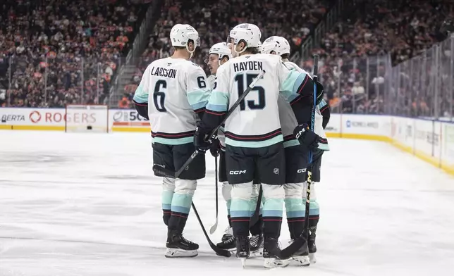 Seattle Kraken players celebrate after a goal against the Edmonton Oilers during first-period NHL hockey game action in Edmonton, Alberta, Monday, Jan. 27, 2025. (Jason Franson/The Canadian Press via AP)
