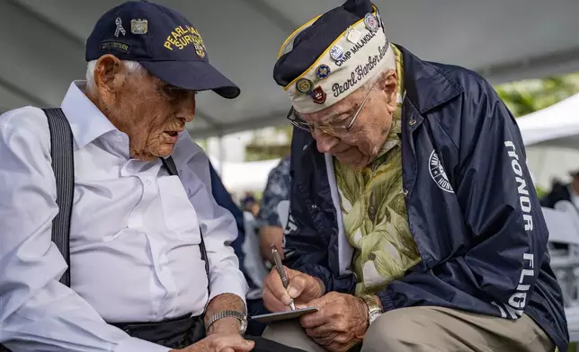 FILE - Pearl Harbor survivors Harry Chandler, 102, left, and Herb Elfring, 101, talk during the 82nd Pearl Harbor Remembrance Day ceremony on Dec. 7, 2023, at Pearl Harbor in Honolulu. (AP Photo/Mengshin Lin, File)