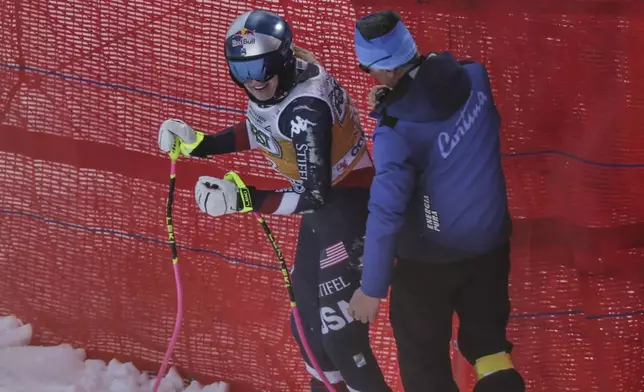 United States' Lindsey Vonn looks on after crashing during an alpine ski, women's World Cup downhill training, in Cortina d'Ampezzo, Italy, Thursday, Jan. 16, 2025. (AP Photo/Marco Trovati)
