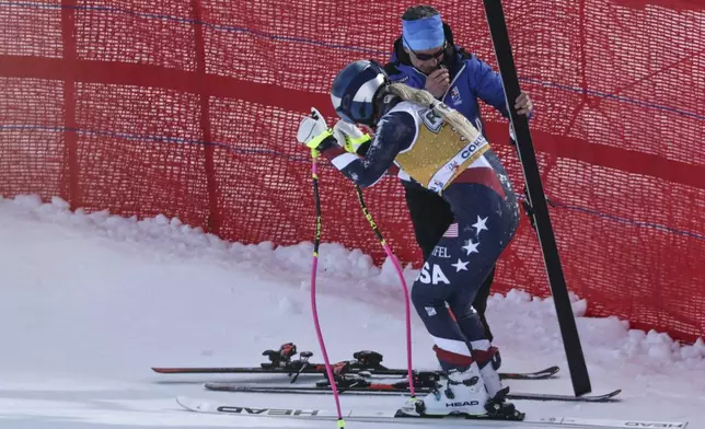 United States' Lindsey Vonn stands up after crashing during an alpine ski, women's World Cup downhill training, in Cortina d'Ampezzo, Italy, Thursday, Jan. 16, 2025. (AP Photo/Marco Trovati)