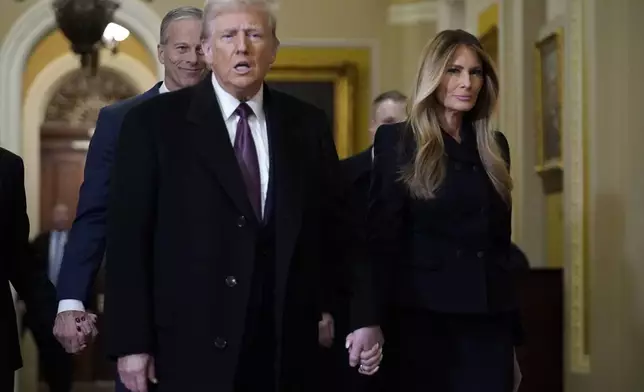 President-elect Donald Trump walks with Melania Trump at the Capitol Wednesday, Jan. 8, 2025, in Washington, as Senate Majority Leader John Thune, R-S.D., follows. (AP Photo/Jose Luis Magana)