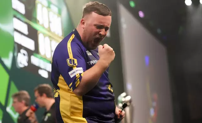 Luke Littler of England celebrates during the final of the World Darts Championship at Alexandra Palace in London, Friday, Jan. 3, 2025. (AP Photo/Kirsty Wigglesworth)