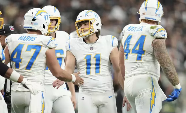 Los Angeles Chargers place kicker Cameron Dicker (11) celebrates with teammates after kicking a field goal during the first half of an NFL football game against the Las Vegas Raiders in Las Vegas, Sunday, Jan. 5, 2025. (AP Photo/John Locher)