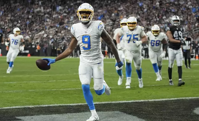 Los Angeles Chargers wide receiver DJ Chark Jr. (9) celebrates after scoring against the Las Vegas Raiders during the first half of an NFL football game in Las Vegas, Sunday, Jan. 5, 2025. (AP Photo/John Locher)