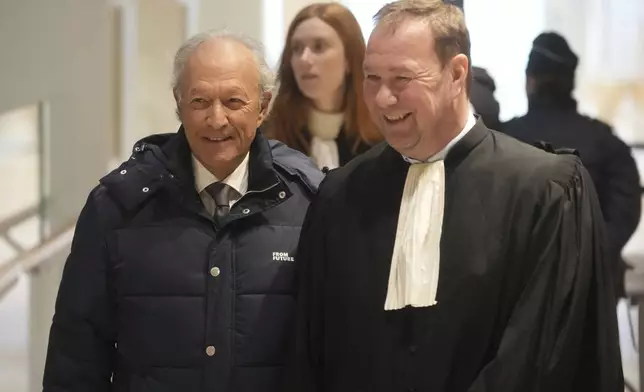 Thierry Gaubert, left, a former close adviser to former French President Nicolas Sarkozy arrives at the courtroom as Sarkozy goes on trial over alleged illegal financing of his 2007 presidential campaign by the government of late Libyan leader Moammar Gadhafi, Monday, Jan. 6, 2025 in Paris. (AP Photo/Thibault Camus)