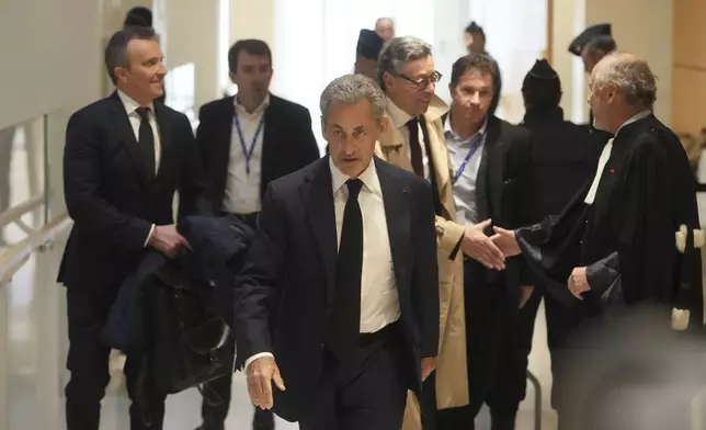 Former French President Nicolas Sarkozy arrives as he goes on trial over alleged illegal financing of his 2007 presidential campaign by the government of late Libyan leader Moammar Gadhafi, Monday, Jan. 6, 2025 in Paris. (AP Photo/Thibault Camus)