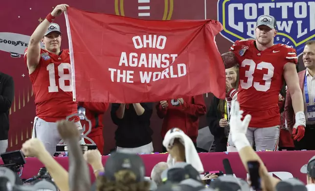 Ohio State quarterback Will Howard (18) and defensive end Jack Sawyer (33) celebrate after the Cotton Bowl College Football Playoff semifinal game against Texas, Friday, Jan. 10, 2025, in Arlington, Texas. (AP Photo/Gareth Patterson)