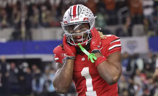 Ohio State running back Quinshon Judkins (1) reacts after scoring a touchdown against Texas during the second half of the Cotton Bowl College Football Playoff semifinal game, Friday, Jan. 10, 2025, in Arlington, Texas. (AP Photo/Gareth Patterson)