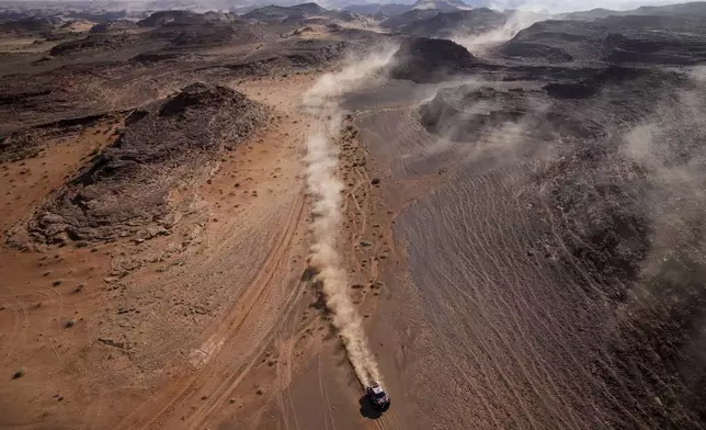 Driver Henk Lategan and co-driver Brett Cummings compete during the fourth stage of the Dakar Rally between Al Henakiyah and Alula, Saudi Arabia, Wednesday, Jan. 8, 2025. (AP Photo/Christophe Ena)