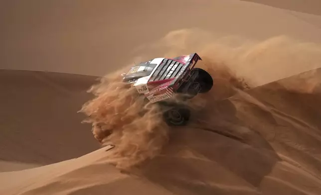 Driver Simon Vitse and co-driver Max Delfino compete during the seventh stage of the Dakar Rally with start and finish in Al Duwadimi, Saudi Arabia, Sunday, Jan. 12, 2025. (AP Photo/Christophe Ena)